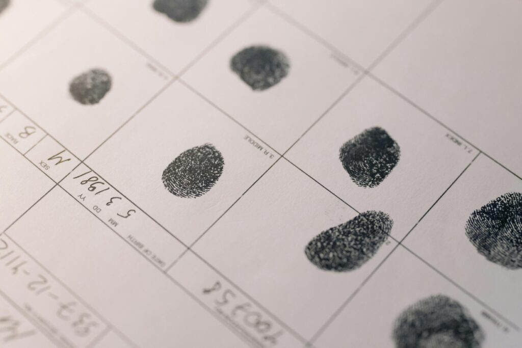 pexels-photo-8382611-8382611 Detailed fingerprints on official document, highlighting identity verification process.